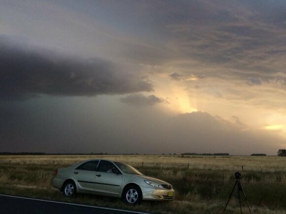 Sun setting behind complex with strong outflow